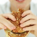 boy eating hamburger fast food