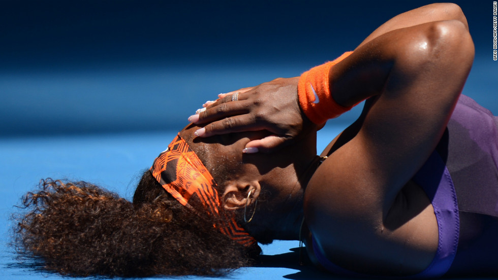 Serena Williams of the United States falls to the court during her first-round match against Romania&#39;s Edina Gallovits-Hall on January 15.