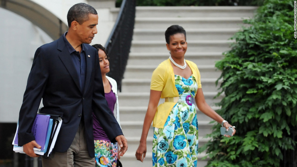 Obama has been known to wear dresses from mass retailer Talbots and accessorize them with signature pieces such as this sweater from Dear Cashmere and a belt by Sonia Rykiel, worn in July 2009, &lt;a href=&quot;http://mrs-o.com/newdata/2009/7/5/bon-voyage.html&quot; target=&quot;_blank&quot;&gt;according to Mrs. O&lt;/a&gt;.