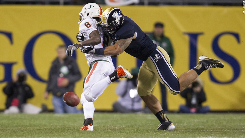 Te&#39;o tackles Miami running back Duke Johnson during the Fighting Irish game against the Miami Hurricanes in Chicago on October 6. Notre Dame defeated Miami 41-3. 