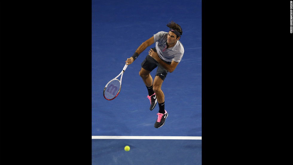 Roger Federer of Switzerland serves in his fourth-round match against Canadian Milos Raonic on January 21. Federer won 6-4, 7-6(4), 6-2.