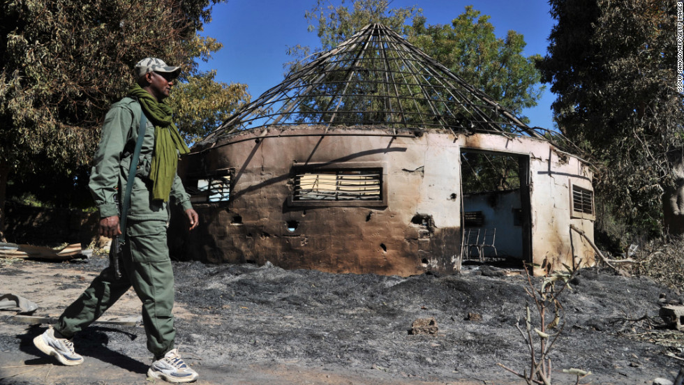 A Malian soldier walks past a army building that was taken by the jihadists before being destroyed during aerial bombing in Diabaly on January 21.