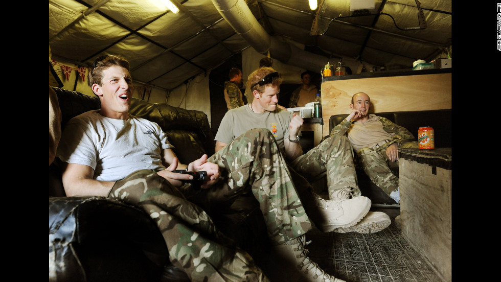 Harry plays video games with fellow pilots Capt. Simon Beattie, left, and Sgt. James John.