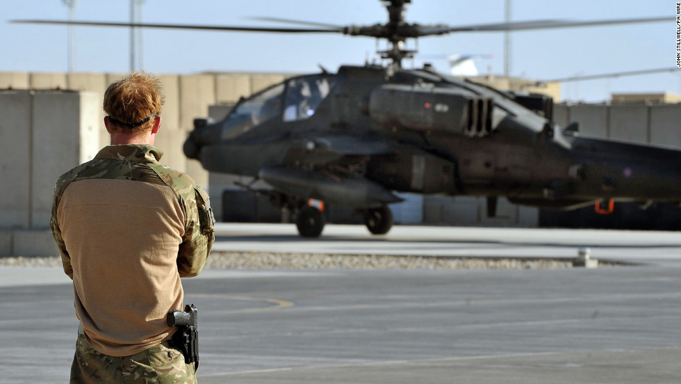 An Apache helicopter, returning from a mission, lands at Camp Bastion as Harry watches on November 3, 2012.