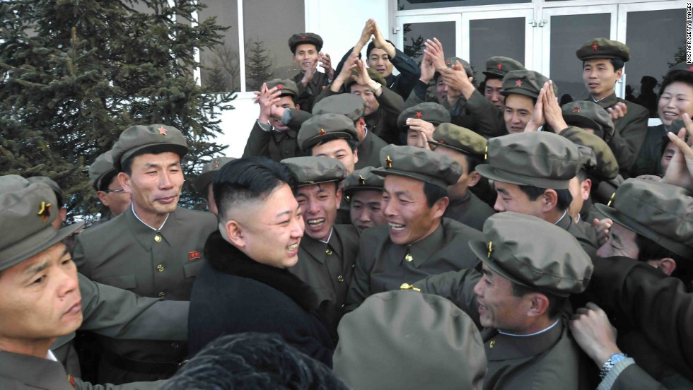 In a photo released by the official North Korean news agency in December 2012, Kim celebrates a rocket&#39;s launch with staff from the satellite control center in Pyongyang.