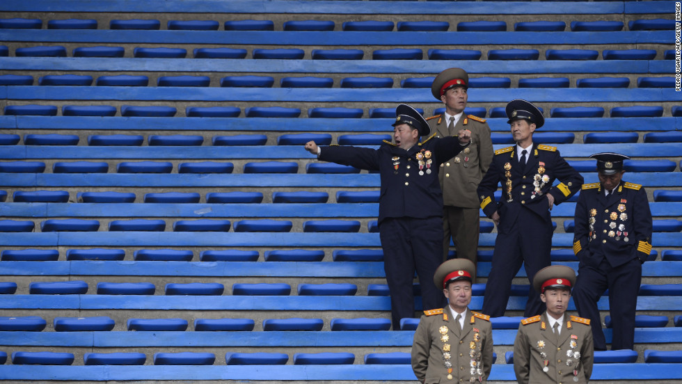 North Korean soldiers relax at the end of an official ceremony attended by leader Kim Jong Un at a stadium in Pyongyang in April 2012.