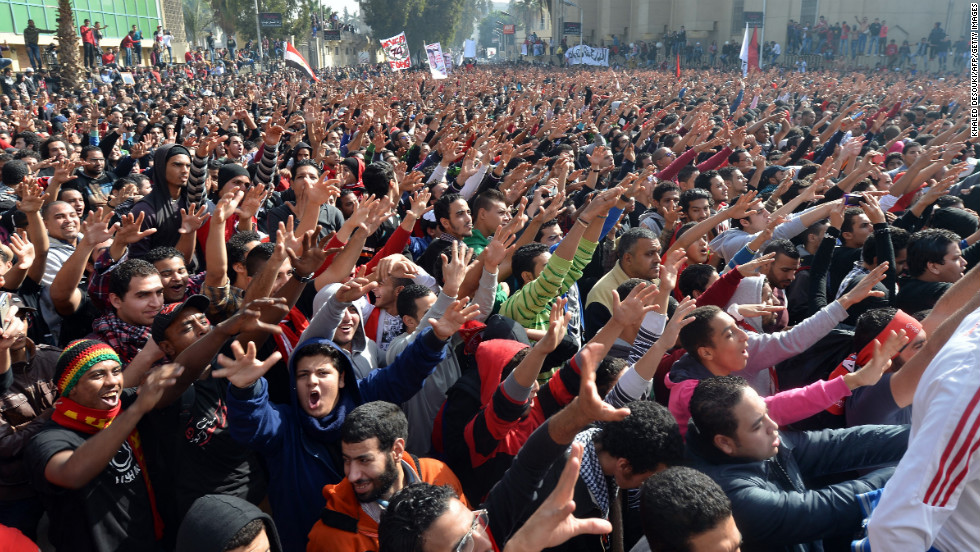 Egyptian fans of Al-Ahly football club celebrate outside the club&#39;s headquarters in Cairo on January 26.