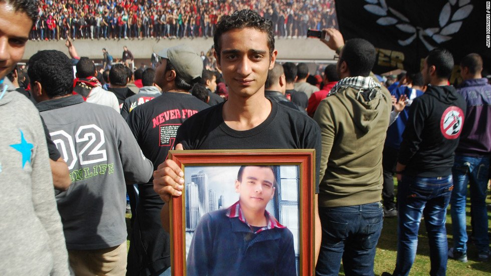 Many of the victims&#39; families were also there, holding pictures of loved ones. Here one young fan holds a portrait of his best friend, who died in Port Said.