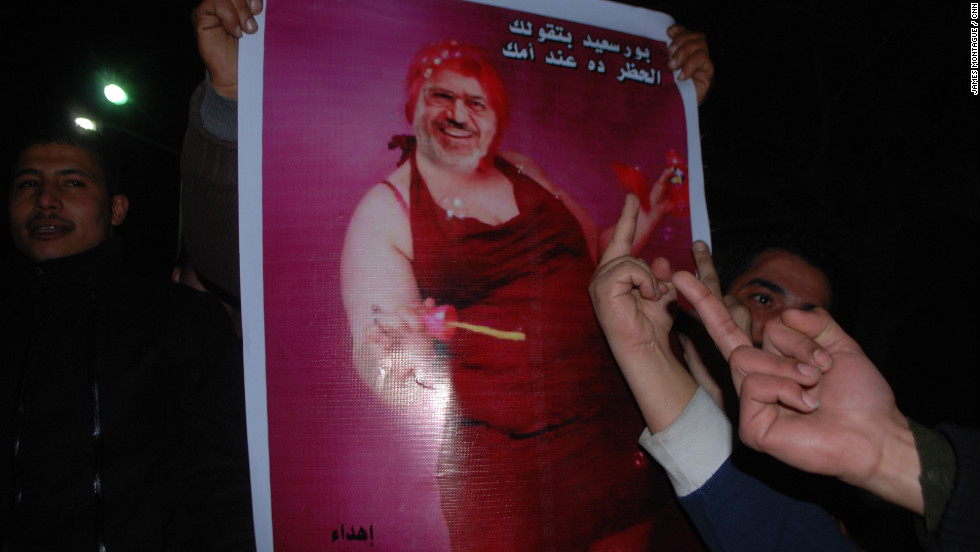 Meanwhile, in Port Said, the announcement sparked violence that led to the deaths of more than 30 people and the imposition of a curfew by President Morsy. A protest was organized to break the curfew. Here a protester carries a picture of Morsy blowing bubbles.