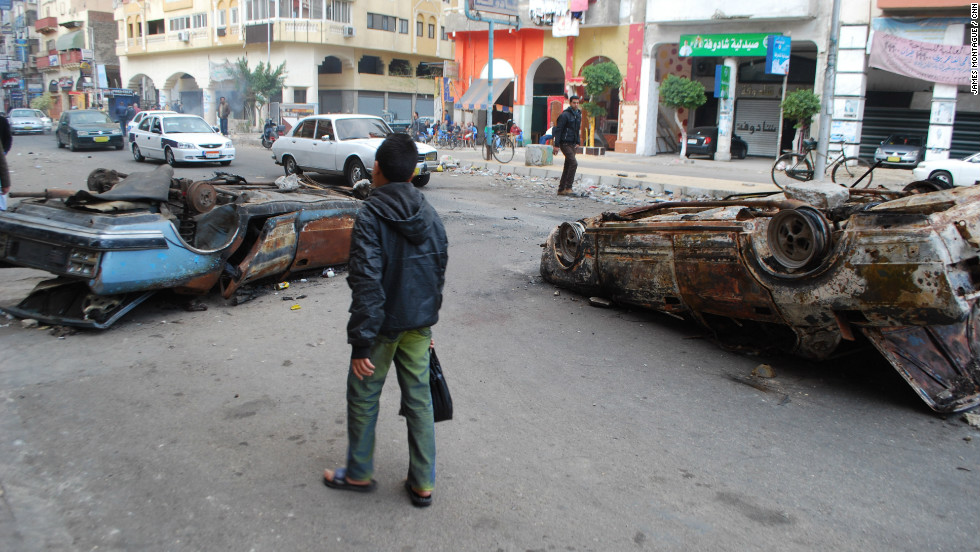The following day, after the protest, burnt out cars remained in the street.