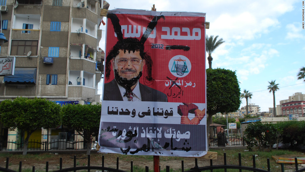 A defaced election campaign poster for President Morsy found nearby.