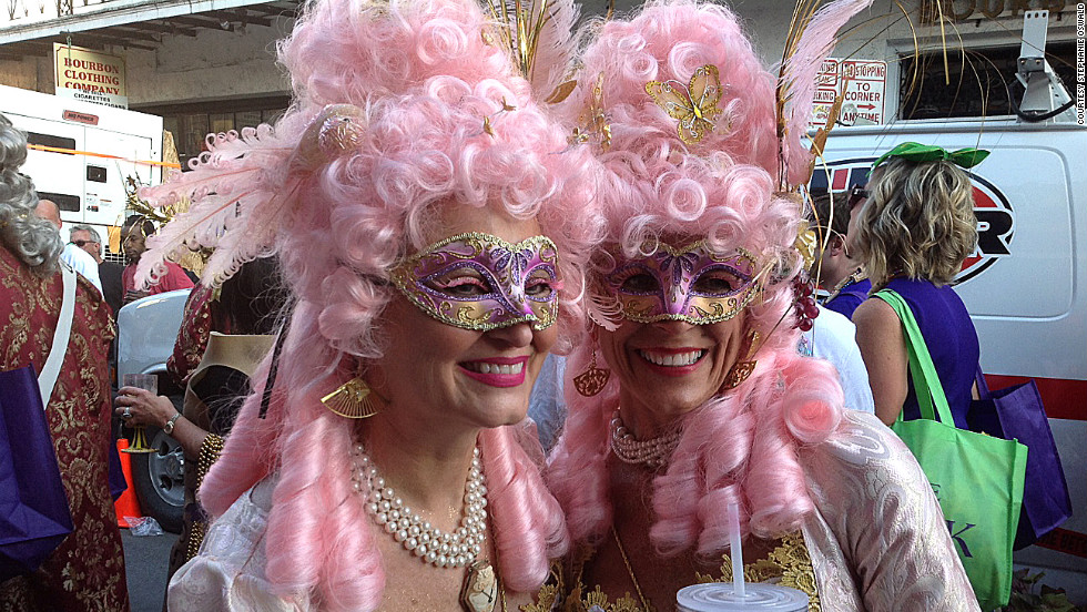 Two ladies from the Krewe of Cork display their Carnival attire during an afternoon parade through the French Quarter.