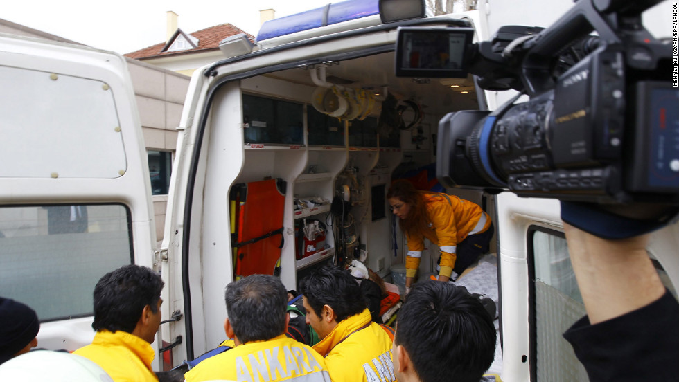 An injured person is put into an ambulance in front of U.S. Embassy.