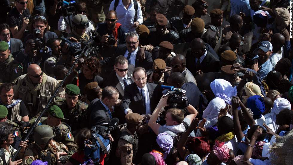 Malians welcome France&#39;s President Francois Hollande as he arrives in Timbuktu on Saturday, February 2. French-led troops are working to secure the area against Islamist militants.