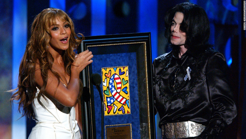 Having stepped out on her own, Beyonce presents the humanitarian award to Michael Jackson at the 2003 Radio Music Awards in Las Vegas on October 27, 2003.