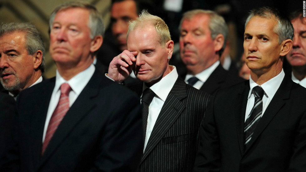 Paul Gascoigne wipes away a tear at the funeral of his former England boss Bobby Robson. Gary Lineker is on his left.  