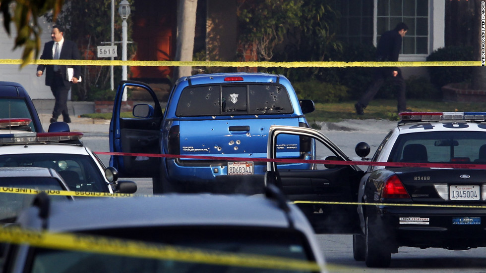 Detectives investigate the scene where officers fired on a vehicle they believed was Christopher Dorner&#39;s on February 7, in Torrance, California. Two people in the truck were wounded.  