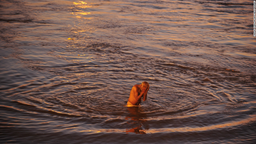 A devotee takes a holy dip at the Sangam, the confluence of the rivers Ganges and Yamuna and the mythic Saraswati on February 7.