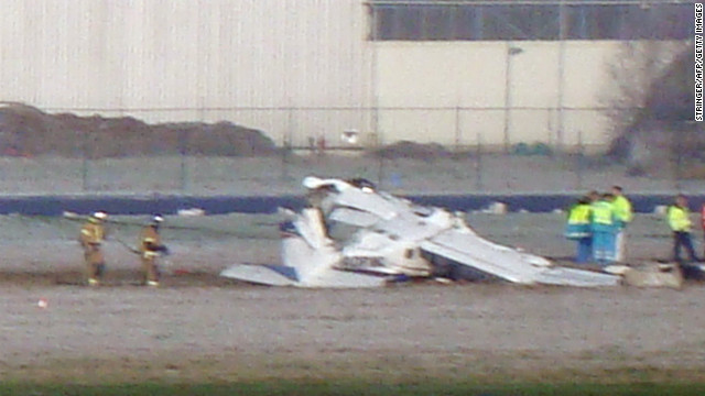 Rescuers gather around the crashed Cessna passenger plane at Brussels South airport in Charleroi, on February 9.