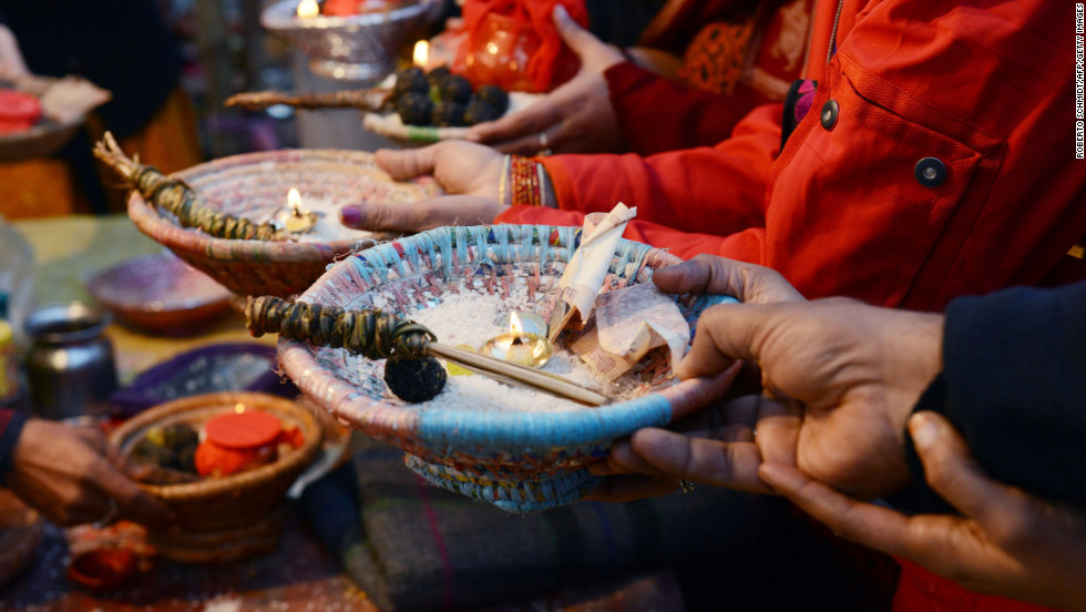 Hindu devotees hold offerings during a blessing ceremony on the banks of the Sangam on February 10.