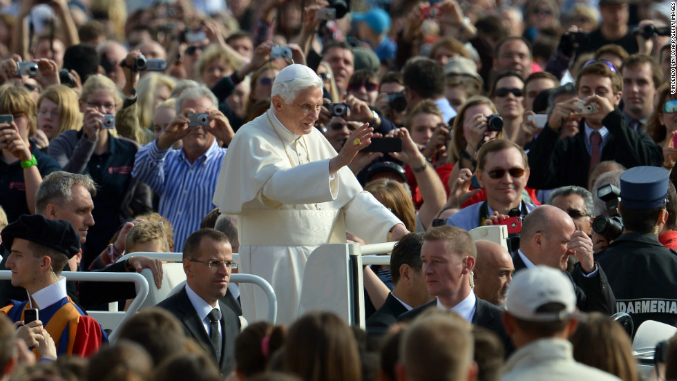 Benedict waves to pilgrims as he arrives at St. Peter&#39;s Square for his weekly address in October 2012.