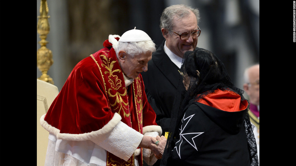 Benedict, accompanied by Grand Master Matthew Festing of the Sovereign Military Order of Malta, right,  shakes hands with a woman after the Mass in St. Peter&#39;s Basilica to mark the 900th anniversary of the Order of the Knights of Malta on February 9, 2013, at the Vatican.    