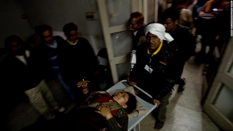 Hospital attendants wheel in a woman injured in the stampede in Allahabad on Sunday, February 10. The stampede occurred about 7 p.m. after someone fell from a platform bridge in Allahabad, the scene of this year&#39;s Kumbh Mela festival, North-Central Railway spokesman Sandeep Mathur said. He said the station was overcrowded with pilgrims, but denied reports that the bridge had collapsed.