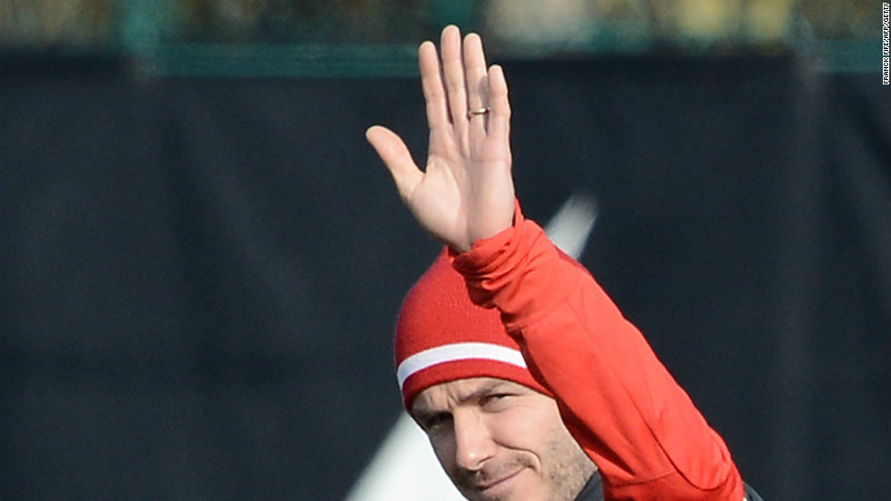 Beckham waves to the waiting press pack as he makes his way out at the club&#39;s Camp des Loges training center in Saint-Germain-en-Laye, near Paris. The session, which was led by PSG&#39;s Italian coach Carlo Ancelotti, was shown live on French television.