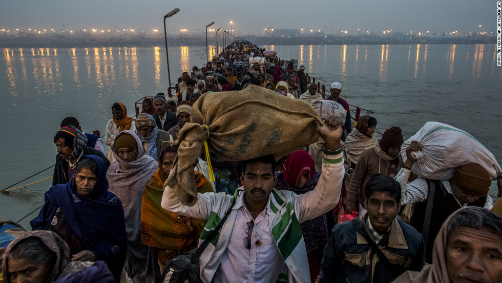 Hindu pilgrims walk across a pontoon bridge on the banks of Sangam on Tuesday, February 12, at the confluence of the rivers Ganges, Yamuna and the mythical Saraswati.