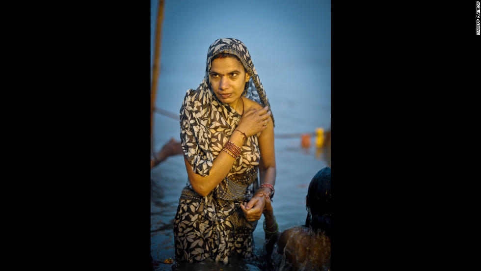 A woman rises out of the Sangam on February 17.