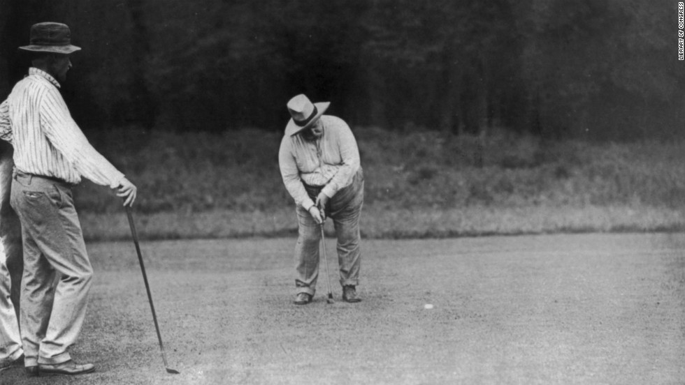 President William Howard Taft, the 27th U.S. president, putts on the green in Chevy Chase, Maryland, on June 28, 1909. He is said to be the first presidential golfer.