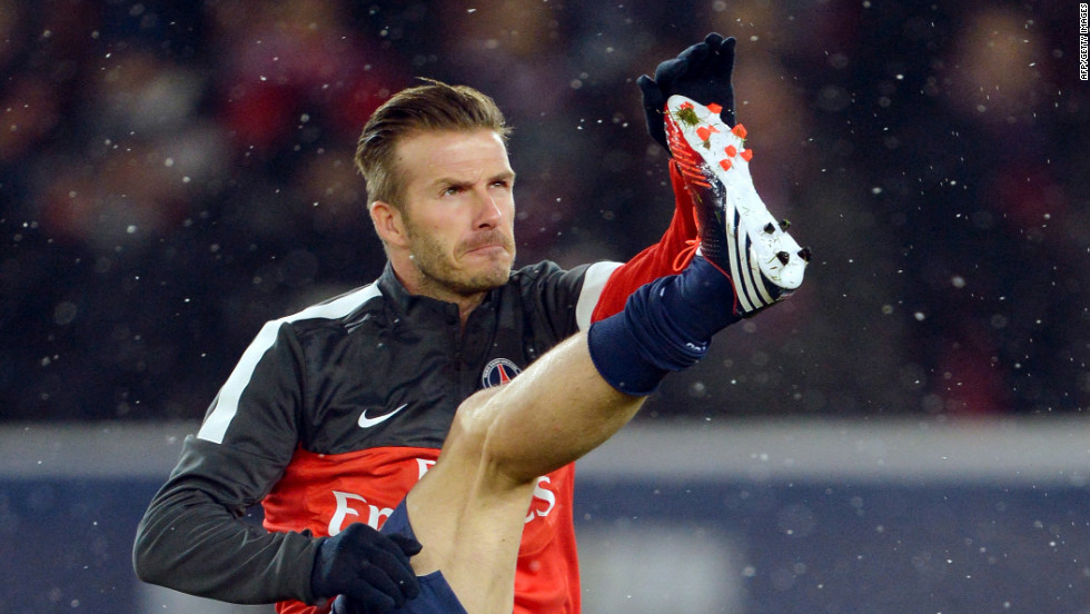 Beckham warms up his 37-year-old limbs ahead of the match against Marseille at the Parc des Princes.