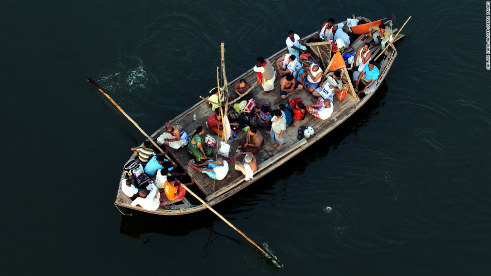 Hindu devotees return by boat after taking a holy dip at Sangam during the Kumbh Mela festival in Allahabad on Wednesday, February 27. 