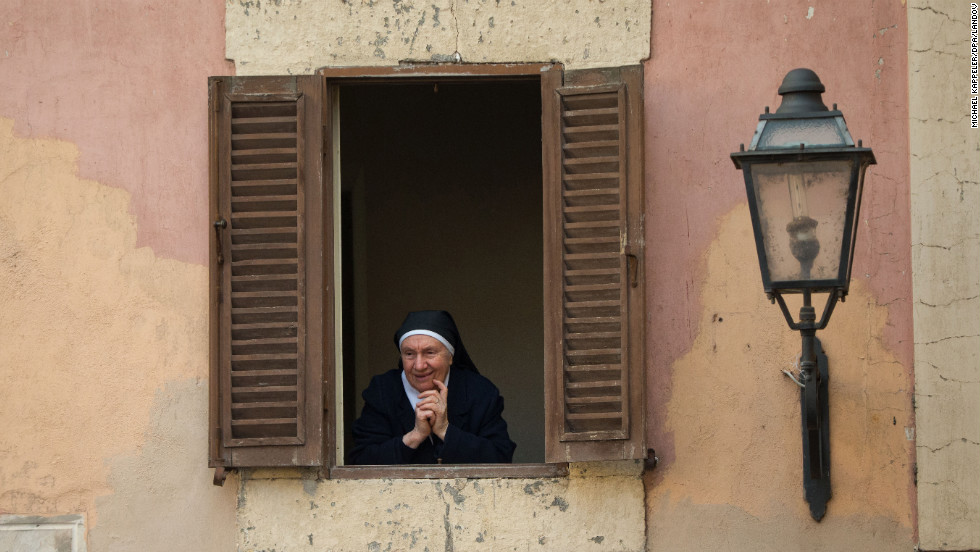 A nun looks out from the Apostolic Palace in Castel Gandolfo.