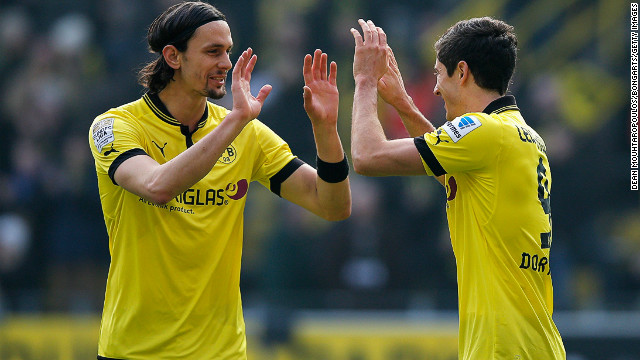 Robert Lewandowski (right) is congratulated by teammate Sebastian Kehl after scoring the second goal against Hannover.