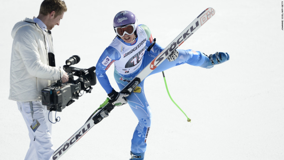 Maze uses her ski as a mock guitar after winning the downhill in Garmish Partenkirchen to break the 2,000-point World Cup record.