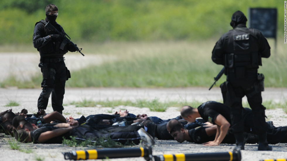 Police commandos from an anti-kidnapping unit, arrest and control a group of &#39;terrorists&#39; during a drill at the Tom Jobim International Airport in Rio de Janeiro, Brazil, on January 13, 2012.