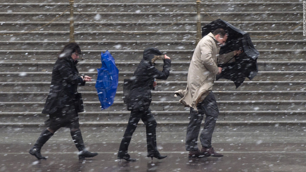 People walk as snow falls at the U.S. Capitol in Washington on Wednesday, March 6.