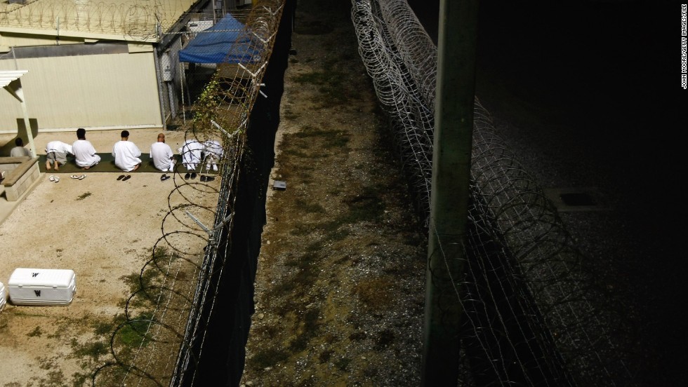 Muslim detainees kneel during early morning prayers in October 2009. Cells are marked with an arrow pointing in the direction of Mecca, which is regarded as Islam&#39;s holy city.