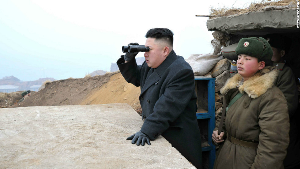 Kim uses a pair of binoculars to look south from the Jangjae Islet Defense Detachment, near South Korea&#39;s Taeyonphyong Island, in March 2013.