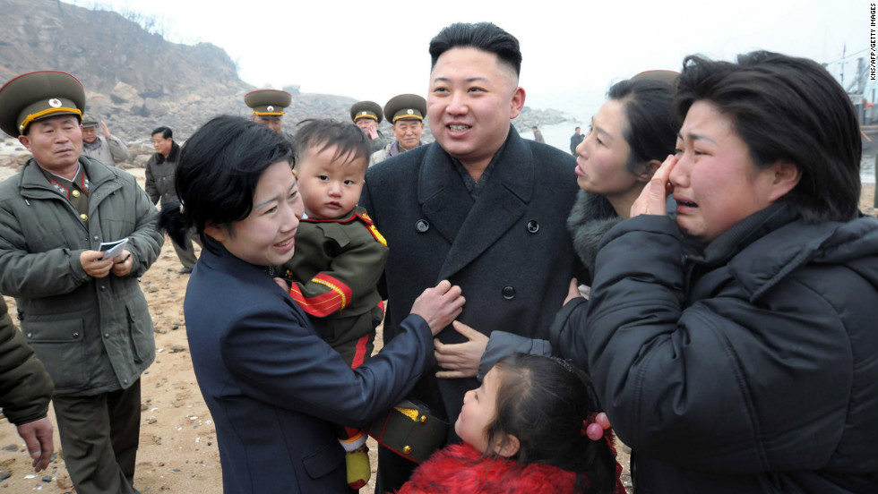 Kim is greeted by a soldier&#39;s family as he inspects the Jangjae Islet Defense Detachment in March 2013.