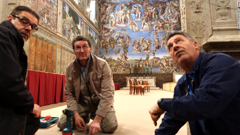 Workers set up inside the Sistine Chapel as preparations begin before the papal conclave on March 9.