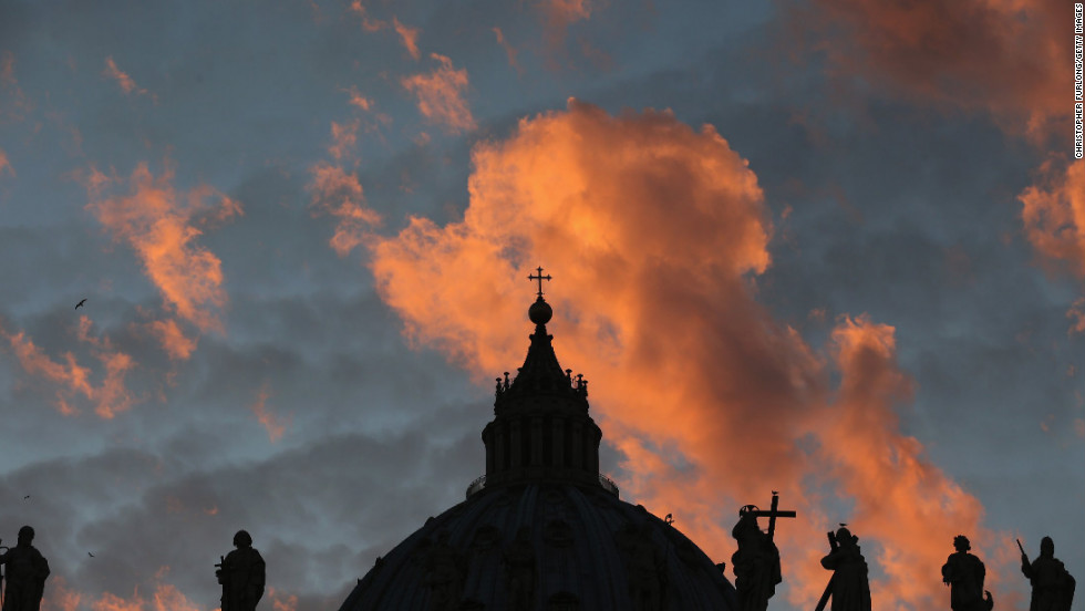 The sun sets over St Peter&#39;s Basilica as cardinals prepare to vote for a new pope on March 9.
