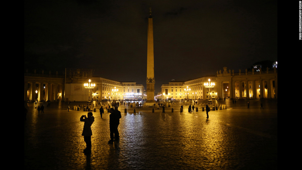 A few pilgrims are present in St. Peter&#39;s Square as night falls on Monday, March 11. 