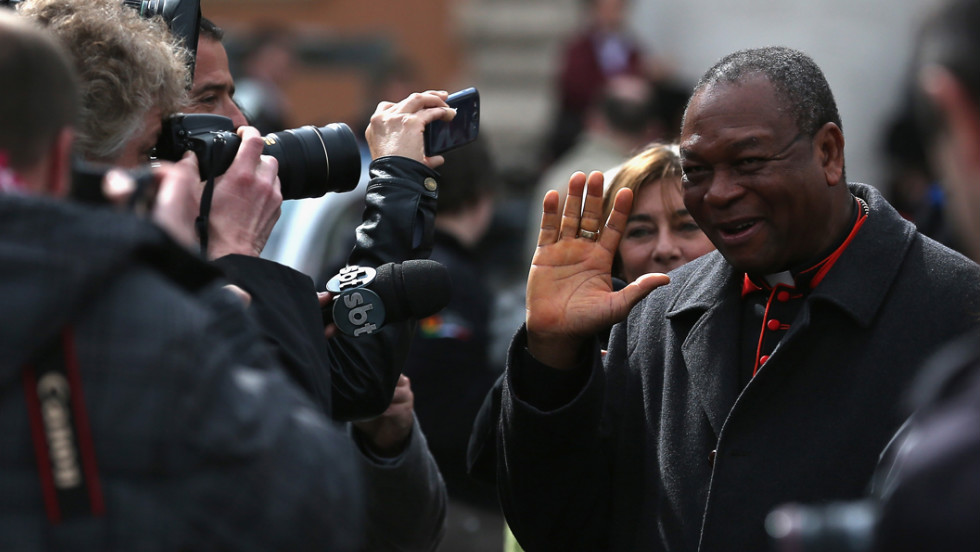 Nigerian Cardinal John Onaiyekan is surrounded by media on March 11 as he leaves the final congregation before cardinals enter the conclave to vote for a new pope.