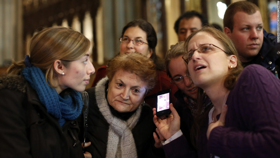 Florencia Silva, right, of Trumbull, Connecticut, and Valentina Bruner of Peru tune in to a webcast of newly elected Pope Francis at St. Patrick&#39;s Cathedral in New York.
