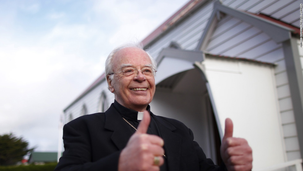 Catholic Monsignor Michael McPartland gestures his approval outside St. Mary&#39;s church after learning of newly elected Pope Francis in Stanley, Falkland Islands.