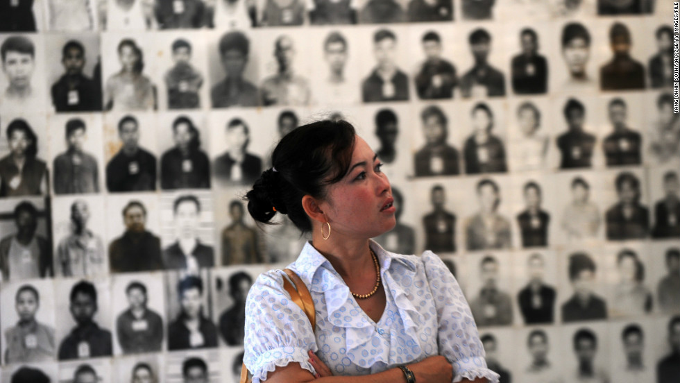A Cambodian woman looks at portraits of victims of the Khmer Rouge at the Tuol Sleng genocide museum in Phnom Penh on November 17, 2011.