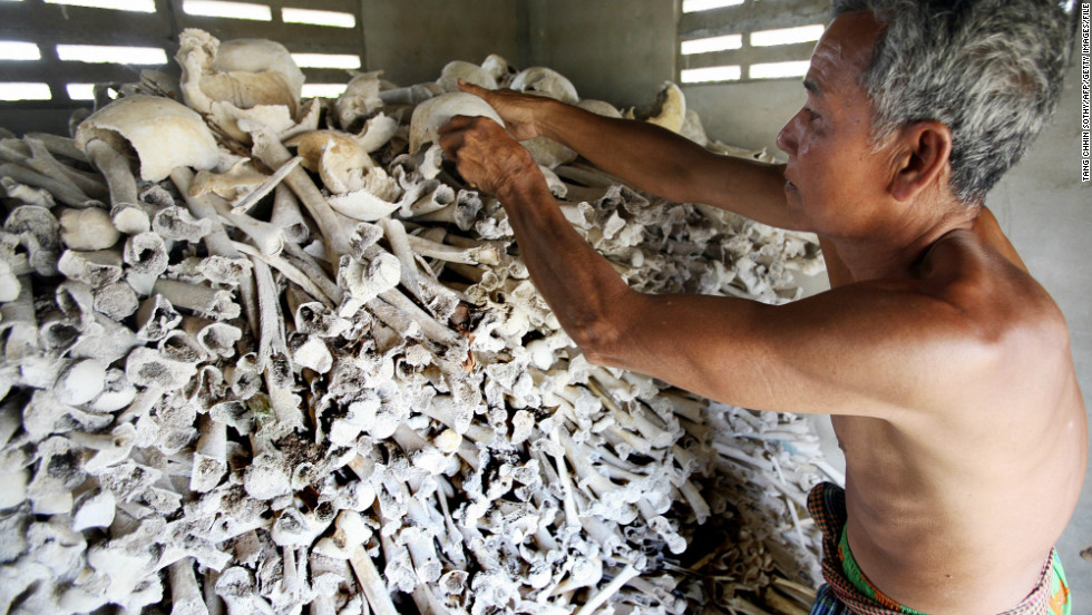 Cambodian Sao Phen prepares skulls and bones of victims of the Khmer Rouge inside a stupa in Kandal province in 2009. 