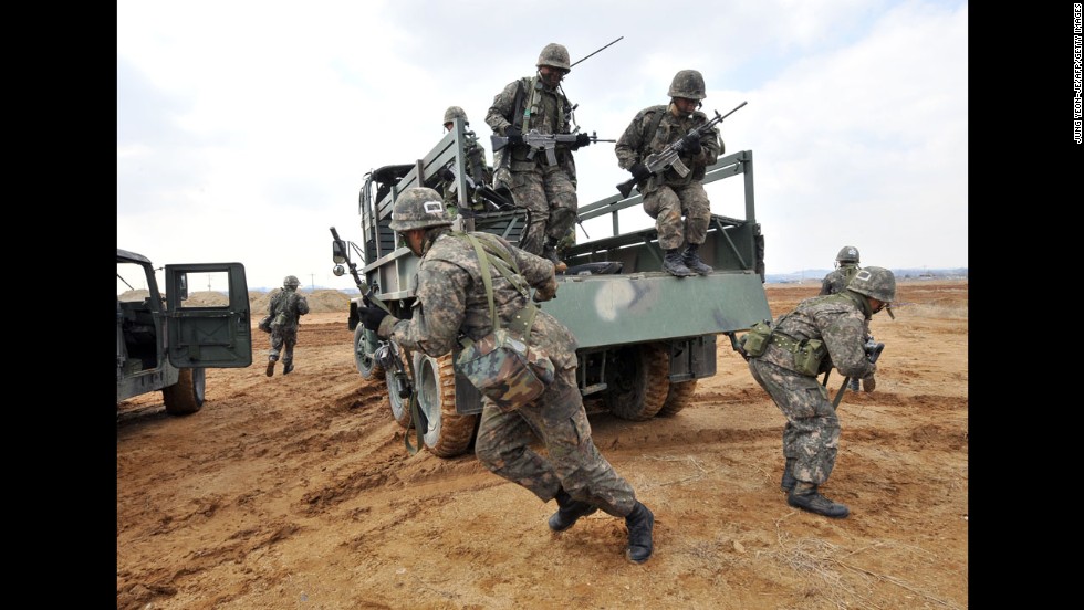 South Korean army soldiers jump off a military truck during a drill outside a U.S. airbase in Pyeongtaek as part of annual joint exercises with the United States on March 14.